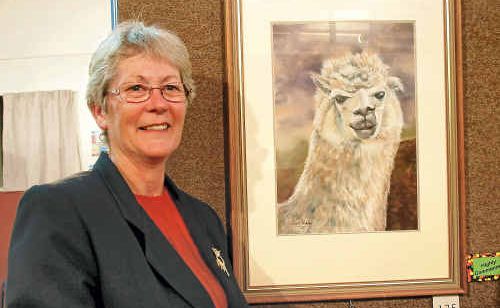 Artist Narell Webber beside her alpaca painting entry, highly commended in the Animalia section. Artist Narell Webber beside her alpaca painting entry, highly commended in the Animalia section.